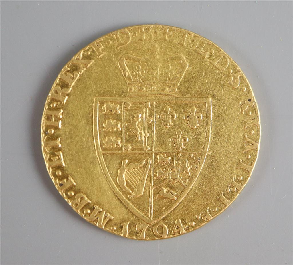 A George III gold guinea, 1794, fifth laureate head, spade shield